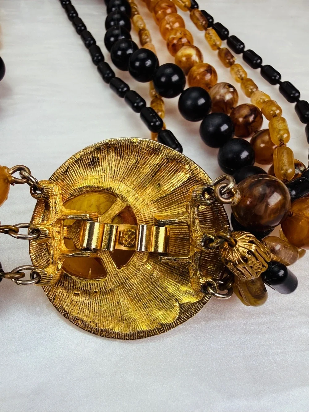 Vintage Multi Strand Black Amber Tone Bead Necklace Gold Tone Centerpiece